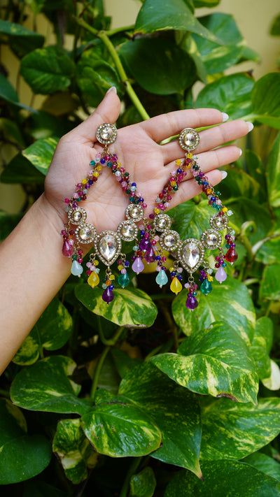 "Traditional chandbaali-style festive earrings with a central teardrop kundan stone, circular kundan accents, and vibrant multicolored bead drops. Part of our festive wear collection, these statement earrings are handcrafted with an antique gold finish—perfect for weddings, celebrations, and ethnic occasions."


