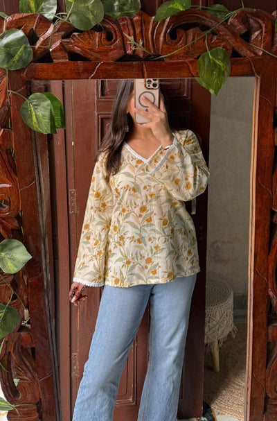 Floral cotton kurti with yellow flower print, V-neck lace detailing, and bell sleeves – Vasanti by Pahraav